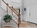 Bright foyer with hardwood floors, a staircase, and a decorative plant at 16018 Hollingbourne Rd, Huntersville, NC 28078