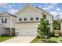 Charming two-story home with neutral siding, manicured lawn, and inviting curb appeal under blue skies at 16018 River Tree Ln, Charlotte, NC 28278