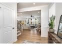 Bright living room with hardwood floors, a ceiling fan, and white trim, creating an inviting and spacious atmosphere at 16018 River Tree Ln, Charlotte, NC 28278