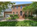 Charming brick two-story home featuring a well-manicured lawn and inviting front entrance at 16028 Cranleigh Dr, Huntersville, NC 28078