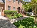 Brick home with manicured front yard, inviting brick staircase and craftsman style front door at 16028 Cranleigh Dr, Huntersville, NC 28078