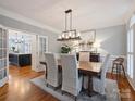 Formal dining room featuring a modern chandelier, neutral paint and french doors at 16308 Woolwine Rd, Charlotte, NC 28278