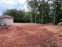 Large lot with a partially cleared backyard surrounded by mature trees at 1987 Robert Rufty Ln, Catawba, NC 28609