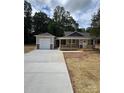 Charming home with covered porch and a detached garage, with a newly paved driveway and landscaping at 1987 Robert Rufty Ln, Catawba, NC 28609