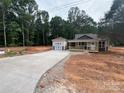Charming single story home with a welcoming front porch and a detached garage along a long, newly paved driveway at 1987 Robert Rufty Ln, Catawba, NC 28609