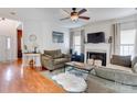 Cozy living room with a fireplace, hardwood floors, and comfortable seating at 2024 Stonewyck Ave, Kannapolis, NC 28081