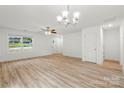 Inviting living room with hardwood floors, neutral walls, and ample natural light from a large window at 210 N Correll St, Landis, NC 28025