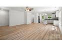 Spacious living area boasts hardwood floors, fresh paint, and seamless kitchen access at 210 N Correll St, Landis, NC 28025