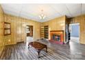 Open living room with fireplace, built in shelves, and laminated wood flooring at 217 S Highland St, Gastonia, NC 28052