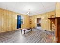 Spacious living room features wood paneled walls and laminated wood flooring at 217 S Highland St, Gastonia, NC 28052