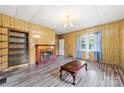 Bright living room showcasing a fireplace, shelving, and a pair of windows at 217 S Highland St, Gastonia, NC 28052