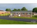 Traditional brick home with attached carport and manicured lawn at 2212 10Th Ne Ave, Hickory, NC 28601