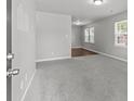 Spacious living room with plush gray carpeting, natural light, and neutral walls at 252 Sweet Bay Nw Ln, Concord, NC 28027