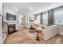 Inviting living room with a fireplace, hardwood floors, and a view into the foyer at 304 Laura Elizabeth Ln, Clover, SC 29710