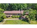 Ranch-style brick house with manicured shrubs and beautiful mature tree at 308 Odell St, Kannapolis, NC 28083