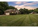 Ranch-style brick home featuring a well-manicured lawn and an attached garage at 3998 Holly Springs Dr # 20, Newton, NC 28658