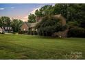 Beautiful home exterior with large lawn and mature tree at 3998 Holly Springs Dr # 20, Newton, NC 28658