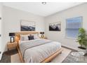 Serene primary bedroom with a plush bed, neutral decor, and ample natural light creating a relaxing retreat at 4026 Honey Locust Dr, Charlotte, NC 28215