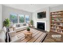 Bright living room features a fireplace, large windows, and stylish decor, great for relaxation and entertaining at 4026 Honey Locust Dr, Charlotte, NC 28215