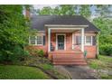Charming brick home featuring a quaint front porch and classic architectural details at 411 Hanna St, Gastonia, NC 28052