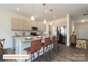 Modern kitchen featuring a spacious island, granite countertops, and stainless steel appliances at 518 Hullview Vista Vis # 15, Monroe, NC 28110
