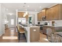 Bright, open kitchen with a large island, stainless steel appliances, and stylish pendant lighting at 518 Hullview Vista Vis # 15, Monroe, NC 28110