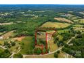 Wide aerial view of property lines showcasing the lush, green landscape, mature trees, and home on acreage at 5258 E Bandys Cross Rd, Catawba, NC 28609