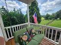 Relax on the porch swing with a view of a lush, green, beautifully landscaped yard at 5258 E Bandys Cross Rd, Catawba, NC 28609