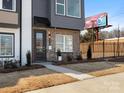 Modern townhome exterior features a brick facade, sleek black accents, and professional landscaping at 5508 Swaling St, Charlotte, NC 28217