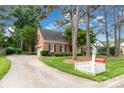 View of brick home, driveway, manicured lawn and a red mailbox with the house number 5517, creating a welcoming curb appeal at 5517 Alexa Rd, Charlotte, NC 28277