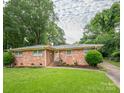A single-story brick home with a well-maintained lawn and mature landscaping at 5629 Ruth Dr, Charlotte, NC 28215