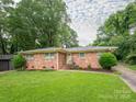 A single-story brick home with a well-maintained lawn and mature landscaping at 5629 Ruth Dr, Charlotte, NC 28215
