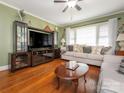 Inviting living room featuring hardwood floors, a ceiling fan, and comfortable seating at 5629 Ruth Dr, Charlotte, NC 28215