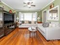 Inviting living room featuring hardwood floors, a ceiling fan, and abundant natural light at 5629 Ruth Dr, Charlotte, NC 28215