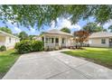 Quaint single-story house boasts a cozy front porch, meticulous landscaping, and an expansive concrete driveway at 613 Church St, Belmont, NC 28012