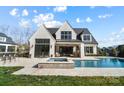 Luxury home with a large in-ground pool, hot tub, and covered patio for outdoor relaxation and entertaining at 7215 Alexander Rd # 4, Charlotte, NC 28270