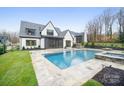 Resort-style backyard featuring a pristine pool, spa, and beautifully landscaped yard at 7215 Alexander Rd # 4, Charlotte, NC 28270