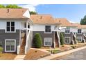 Charming exterior view of the townhouse with stairs leading to the front door and manicured landscaping at 753 Southwest Dr, Davidson, NC 28036