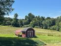 Charming outbuilding/shed offers great storage on a large lot with beautiful mature trees. Great for hobby or storage at 765 York Institute Rd, Hiddenite, NC 28636
