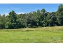 Beautiful lot with lush green field, perfect for building your dream home in a private and serene setting at 765 York Institute Rd, Hiddenite, NC 28636