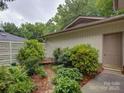 Private backyard offers a tranquil seating area amidst lush greenery at 8 Sunrise Point Rd, Lake Wylie, SC 29710