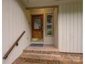 Covered entrance has brick steps and a leaded glass wooden front door at 8 Sunrise Point Rd, Lake Wylie, SC 29710