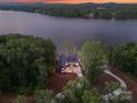 Aerial view of home nestled among lush trees, offering privacy and serene lake views, showcasing its secluded location at 8066 Edgewater Dr # 103, Norwood, NC 28128