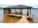 Covered dock featuring an expansive deck and boat slip at 8066 Edgewater Dr # 103, Norwood, NC 28128