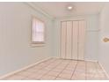 Bright bedroom with light-blue walls, neutral floors, and a closet with bi-fold doors at 102 Lake Dr, Hickory, NC 28601
