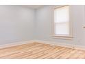Bright bedroom with light-blue walls, wood floors, a window, and white trim at 102 Lake Dr, Hickory, NC 28601