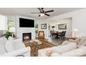 Bright living room boasts fireplace, ceiling fan and an adjacent dining area at 1041 Brawley School Rd, Mooresville, NC 28117