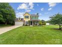 Charming two-story home with a well-manicured lawn and blue sky creating a welcoming curb appeal at 105 Carmel Hills Dr, Gastonia, NC 28056