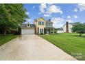 Charming two-story home with a well-manicured lawn and long driveway creates a welcoming curb appeal at 105 Carmel Hills Dr, Gastonia, NC 28056