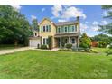 Charming two-story home with a well-manicured lawn and blue sky creating a welcoming curb appeal at 105 Carmel Hills Dr, Gastonia, NC 28056